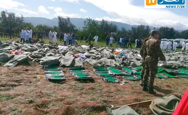In this image from Algerian TV agency Ennahar TV, bodies are gathered near scene of a fatal military plane crash at Boufarik military air base near the Algerian capital, Algiers, Wednesday, April 11, 2018. An Algerian military plane carrying soldiers and their families crashed soon after takeoff Wednesday into a field in northern Algeria, killing more than 250 people in what appeared to be the North African nation's worst-ever plane crash. (Ennahar TV via AP)