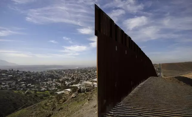FILE - In this Dec. 22, 2018, file photo, Tijuana, Mexico, left, and San Diego, Calif, right, are seen separated by the U.S. border fence. (AP PhotoDaniel Ochoa de Olza, File)
