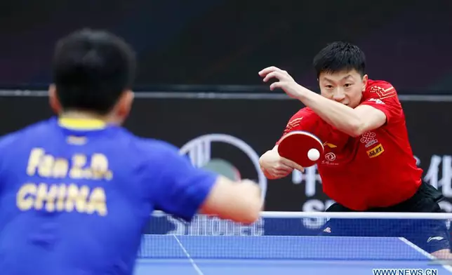 Ma Long (R) of China returns the ball during the men's singles final match between Fan Zhendong of China and his compatriot Ma Long at 2020 ITTF Men's World Cup in Weihai, east China's Shandong Province, Nov. 15, 2020.