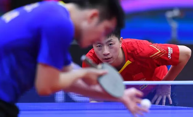 Ma Long of China reacts during the men's singles final match between Fan Zhendong of China and his compatriot Ma Long at 2020 ITTF Men's World Cup in Weihai, east China's Shandong Province, Nov. 15, 2020.