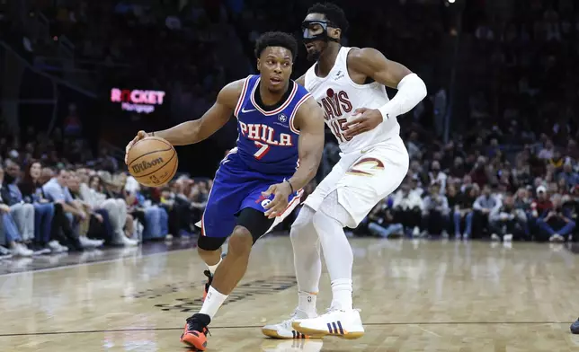 Philadelphia 76ers guard Kyle Lowry (7) drives against Cleveland Cavaliers guard Donovan Mitchell (45) during the first half of an NBA basketball game Friday, March 29, 2024, in Cleveland. (AP Photo/Ron Schwane)