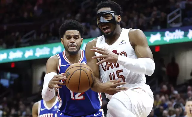 Philadelphia 76ers forward Tobias Harris (12) steals the ball from Cleveland Cavaliers guard Donovan Mitchell (45) during the second half of an NBA basketball game Friday, March 29, 2024, in Cleveland. (AP Photo/Ron Schwane)