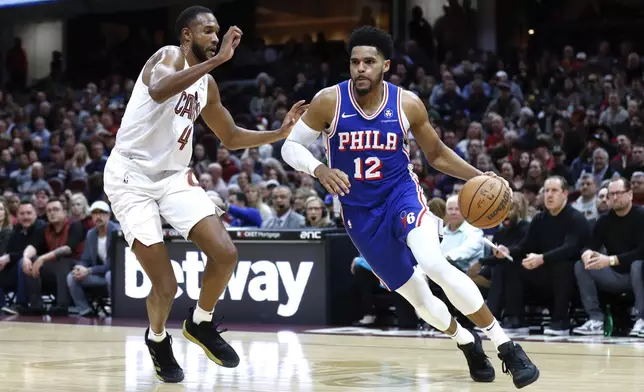 Philadelphia 76ers forward Tobias Harris (12) drives against Cleveland Cavaliers forward Evan Mobley (4) during the first half of an NBA basketball game Friday, March 29, 2024, in Cleveland. (AP Photo/Ron Schwane)