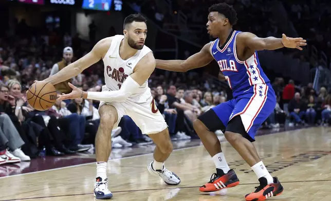 Cleveland Cavaliers guard Max Strus (1) looks to pass the ball as Philadelphia 76ers guard Kyle Lowry (7) defends during the second half of an NBA basketball game Friday, March 29, 2024, in Cleveland. (AP Photo/Ron Schwane)