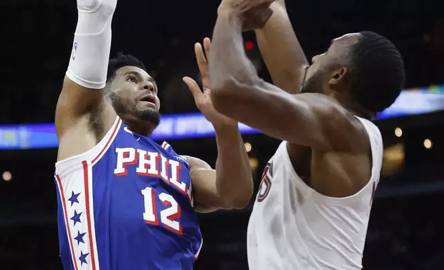 Philadelphia 76ers forward Tobias Harris (12) shoots against Cleveland Cavaliers forward Evan Mobley during the first half of an NBA basketball game Friday, March 29, 2024, in Cleveland. (AP Photo/Ron Schwane)