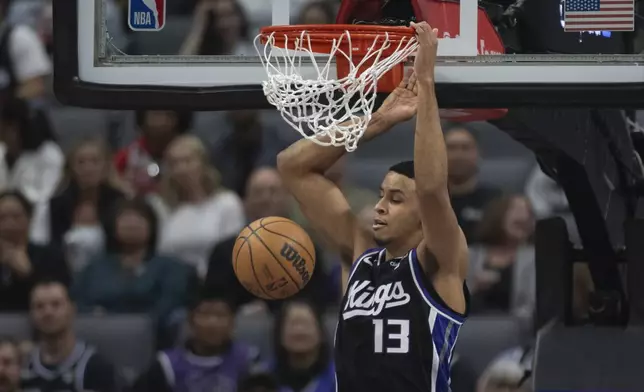 Sacramento Kings forward Keegan Murray scores a basket in the first half of an NBA basketball game against the Philadelphia 76ers in Sacramento, Calif., Monday, March 25, 2024. (AP Photo/José Luis Villegas)