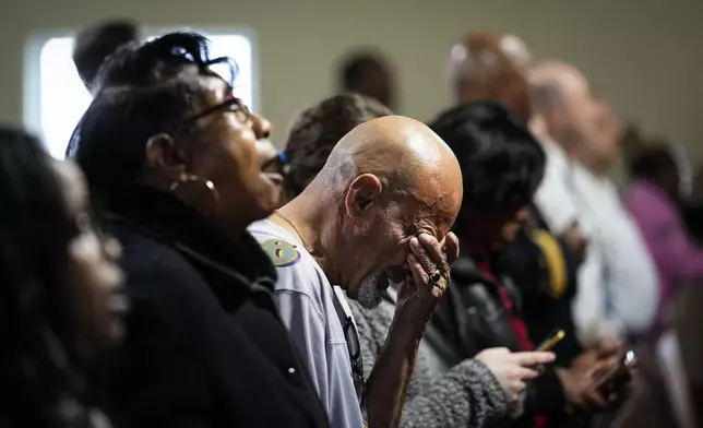 People gather for a vigil near the scene where a container ship collided with a support on the Francis Scott Key Bridge, at Mount Olive Baptist Church in Dundalk, Md., Tuesday, March 26, 2024. (AP Photo/Matt Rourke)