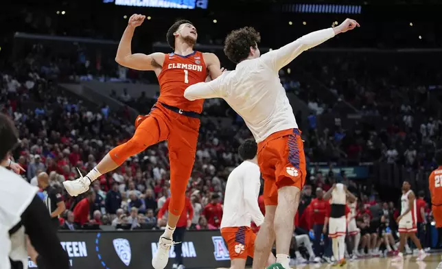 Clemson guard Chase Hunter (1) and forward Daniel Nauseef (32) celebrate after a win over Arizona in a Sweet 16 college basketball game in the NCAA tournament Thursday, March 28, 2024, in Los Angeles. (AP Photo/Ryan Sun)