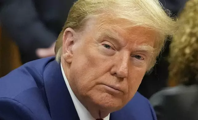 Former President Donald Trump awaits the start of a pre-trial hearing with his defense team at Manhattan criminal, Monday, March 25, 2024, in New York. A judge will weigh on Monday when the former president will go on trial. (AP Photo/Mary Altaffer, Pool)