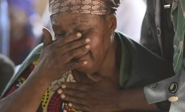 Family members and relatives of the bus crash victims gather at the ZCC Church, where victims used for church services in the Molepolole village near Gaborone, Botswana, Friday, March 29, 2024. A bus carrying Easter pilgrims from Botswana to Moria in South Africa crashed en route in Mokopane, South Africa, claiming the lives of some 45 people. An 8-year-old survived. (AP Photo)