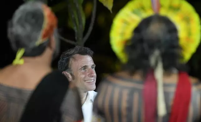 French President Emmanuel Macron smiles while attending a ceremony on Combu Island, near Belem, Para state, Brazil, Tuesday, March 26, 2024. Macron is on a three-day official visit to Brazil. (AP Photo/Eraldo Peres)