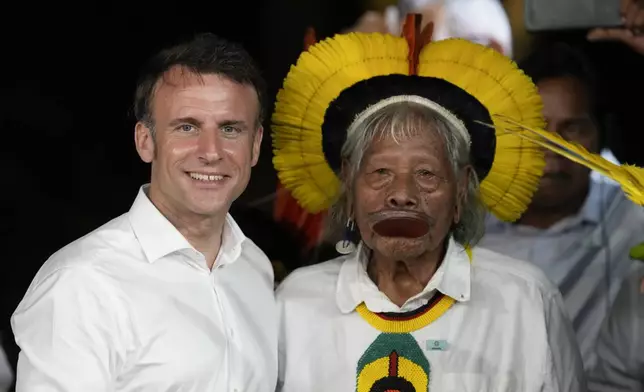 French President Emmanuel Macron, left, and Chief Raoni Metuktire poses for photos after Macron presented Chief Raoni with the French distinction, the Legion of Honor, during a ceremony on Combu Island, near Belem, Para state, Brazil, Tuesday, March 26, 2024. (AP Photo/Eraldo Peres)
