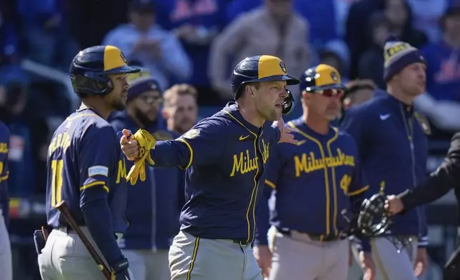 Milwaukee Brewers' Rhys Hoskins yells toward New York Mets' Jeff McNeil as benches cleared during the eighth inning of a baseball game Friday, March 29, 2024, in New York. (AP Photo/Frank Franklin II)