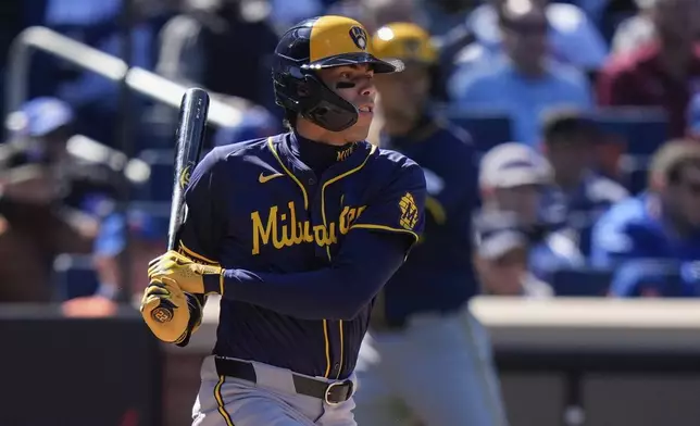 Milwaukee Brewers' Christian Yelich (22) follows through on a single during the fifth inning of a baseball game against the New York Mets Friday, March 29, 2024, in New York. (AP Photo/Frank Franklin II)