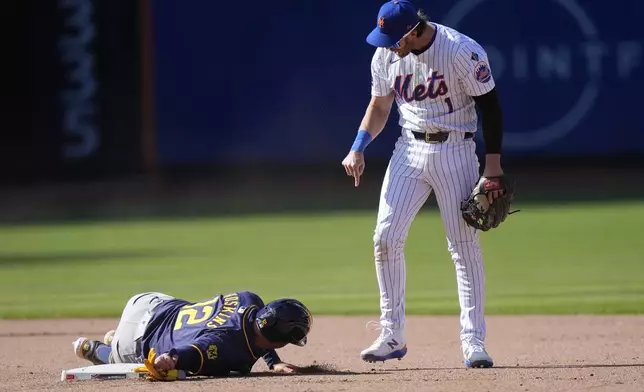 New York Mets' Jeff McNeil (1) exchanges words with Milwaukee Brewers' Rhys Hoskins (12) after Hoskins slid into him during the eighth inning of a baseball game Friday, March 29, 2024, in New York. (AP Photo/Frank Franklin II)