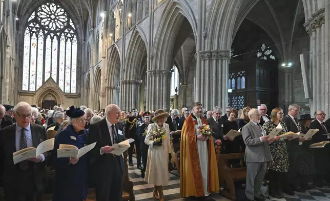 Britain's Queen Camilla, left, and Interim Dean of Worcester Cathedral The Reverend Canon Dr Stephen Edwards, right, arrive for the Royal Maundy Service where The Queen will distribute the Maundy money to 75 men and 75 women, mirroring the age of the monarch, in Worcester Cathedral, Worcester, England, Thursday, March 28, 2024. Maundy Thursday is the Christian holy day falling on the Thursday before Easter. The monarch commemorates Maundy by offering 'alms' to senior citizens. Each recipient receives two purses, one red and one white. (Justin Tallis, Pool Photo via AP)