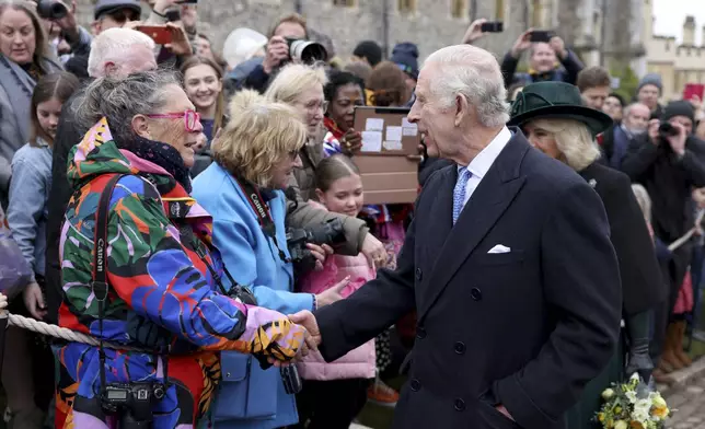 Britain's King Charles III and Queen Camilla greet people after attending the Easter Matins Service at St. George's Chapel, Windsor Castle, England, Sunday, March 31, 2024. (Hollie Adams/Pool Photo via AP)