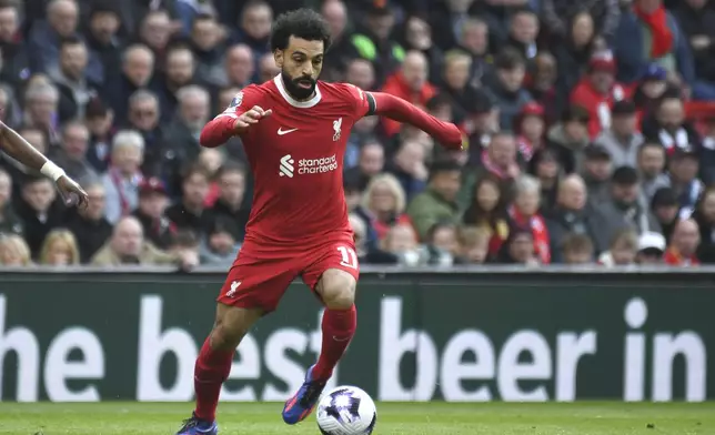 Liverpool's Mohamed Salah in action during the English Premier League soccer match between Liverpool and Brighton and Hove at Anfield Stadium in Liverpool, England, Sunday, March 31, 2024. (AP Photo/Rui Vieira)
