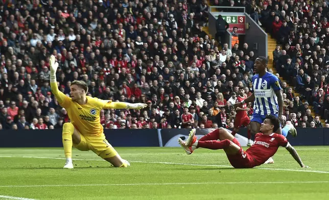 Brighton's goalkeeper Bart Verbruggen, left, fails to save the goal from Liverpool's Luis Diaz, right, during the English Premier League soccer match between Liverpool and Brighton and Hove at Anfield Stadium in Liverpool, England, Sunday, March 31, 2024. (AP Photo/Rui Vieira)