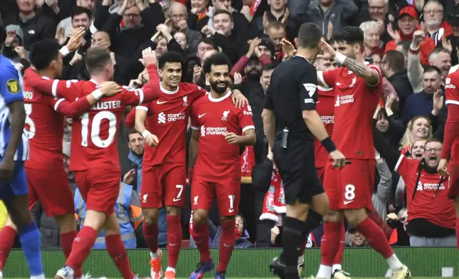Liverpool's Mohamed Salah, centre, celebrates with teammates after scoring his side's second goal during the English Premier League soccer match between Liverpool and Brighton and Hove at Anfield Stadium in Liverpool, England, Sunday, March 31, 2024. (AP Photo/Rui Vieira)