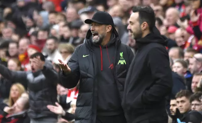 Liverpool's manager Jurgen Klopp, left, reacts during the English Premier League soccer match between Liverpool and Brighton and Hove at Anfield Stadium in Liverpool, England, Sunday, March 31, 2024. (AP Photo/Rui Vieira)