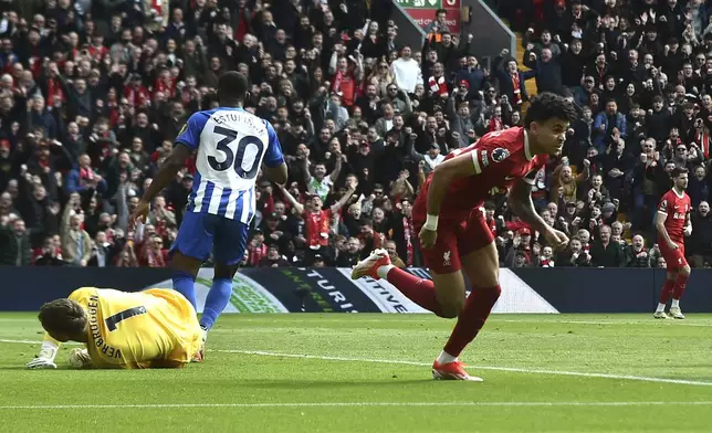 Liverpool's Luis Diaz, right, celebrates after scoring his side's opening goal during the English Premier League soccer match between Liverpool and Brighton and Hove at Anfield Stadium in Liverpool, England, Sunday, March 31, 2024. (AP Photo/Rui Vieira)