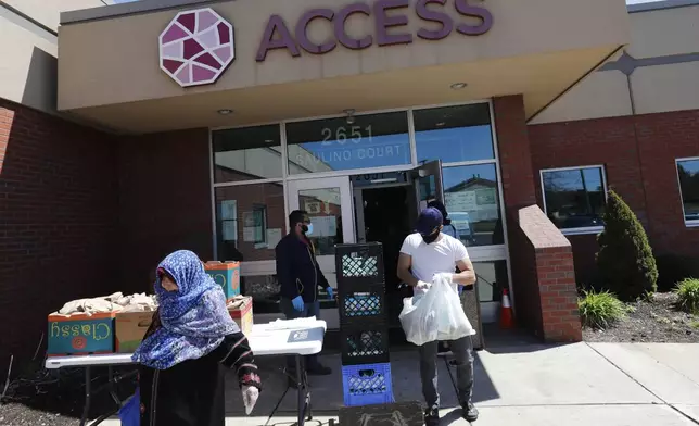 FILE - Workers at ACCESS, the Arab Community Center for Economic and Social Services, help with meals for the Arab community in Dearborn, Mich., May 1, 2020. For the first time in 27 years, the U.S. government on Thursday, March 28, 2024, changed how it categorizes people by race and ethnicity, an effort that federal officials believe will more accurately count residents who identify as Hispanic and of Middle Eastern and North African heritage. (AP Photo/Carlos Osorio, File)