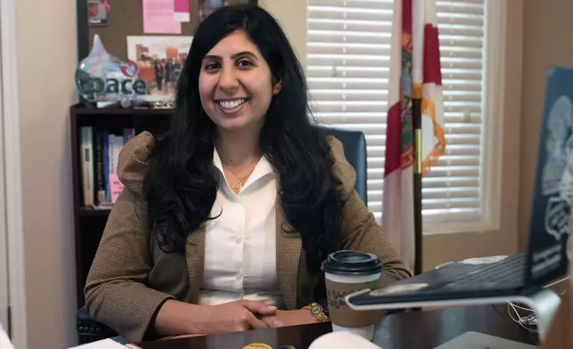 Florida state Rep. Anna Eskamani smiles in her office Wednesday, March 27, 2024, in Orlando, Fla. For the first time in 27 years, the U.S. government is announcing changes to how it categorizes people by race and ethnicity. "It feels good to be seen," said Eskamani, whose parents are from Iran. (AP Photo/John Raoux)