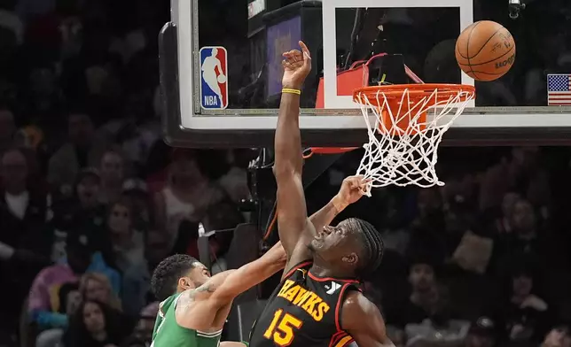 Boston Celtics forward Jayson Tatum (0) has his shot blocked by Atlanta Hawks center Clint Capela (15) during the first half of an NBA basketball game Thursday, March 28, 2024, in Atlanta. (AP Photo/John Bazemore)