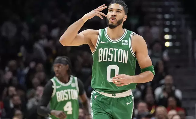 Boston Celtics forward Jayson Tatum (0) reacvts after a three-point basket during the first half of an NBA basketball game against the Atlanta Hawks Thursday, March 28, 2024, in Atlanta. (AP Photo/John Bazemore)