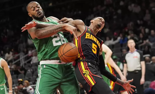 Boston Celtics forward Xavier Tillman (26) and Atlanta Hawks guard Dejounte Murray (5) battle during the first half of an NBA basketball game Thursday, March 28, 2024, in Atlanta. (AP Photo/John Bazemore)