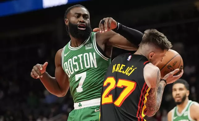 Atlanta Hawks guard Vit Krejci (27) is fouled by Boston Celtics guard Jaylen Brown (7) during the first half of an NBA basketball game Thursday, March 28, 2024, in Atlanta. (AP Photo/John Bazemore)