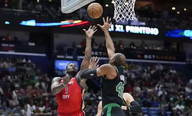 New Orleans Pelicans forward Zion Williamson (1) shoots against Boston Celtics center Al Horford (42) in the first half of an NBA basketball game in New Orleans, Saturday, March 30, 2024. (AP Photo/Gerald Herbert)