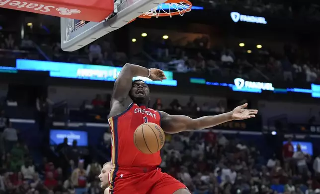 New Orleans Pelicans forward Zion Williamson slam dunks on a breakaway in the first half of an NBA basketball game against the Boston Celtics in New Orleans, Saturday, March 30, 2024. (AP Photo/Gerald Herbert)