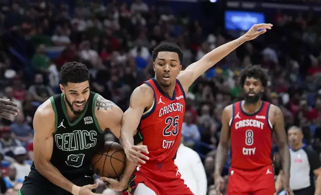 Boston Celtics forward Jayson Tatum (0) battles for control of the ball against New Orleans Pelicans guard Trey Murphy III (25) in the second half of an NBA basketball game in New Orleans, Saturday, March 30, 2024. The Celtics won 104-92. (AP Photo/Gerald Herbert)