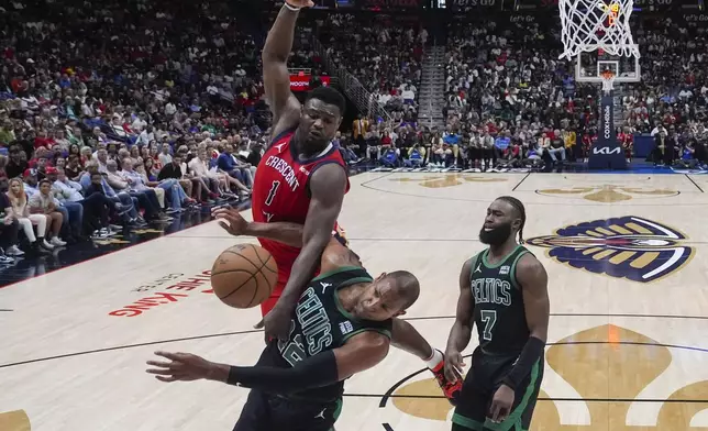 New Orleans Pelicans forward Zion Williamson (1) loses the ball as he drives to the basket against Boston Celtics center Al Horford and guard Jaylen Brown (7) in the second half of an NBA basketball game in New Orleans, Saturday, March 30, 2024. The Celtics won 104-92. (AP Photo/Gerald Herbert)