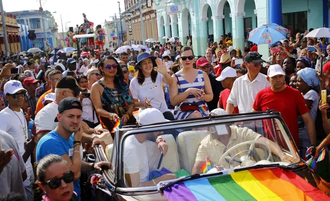 FILE - Mariela Castro, director of Cuba's National Center for Sexual Education, waves from a convertible classic car during a parade marking the International Day Against Homophobia, Transphobia and Biphobia, in Pinar Del Rio, Cuba, May 17, 2018. For years, the movement for LGBTQ+ rights has been proudly led by Cuba’s best-known advocate for gay rights: Mariela Castro, daughter of former President Raul Castro and niece of his brother Fidel. (AP Photo/Desmond Boylan, File)