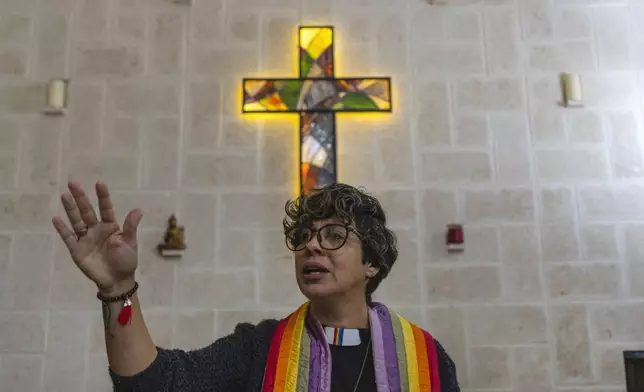 Rev. Elaine Saralegui, wearing a rainbow-colored clergy stole and her clerical collar, leads a service at the Metropolitan Community Church, an LGBTQ+ inclusive house of worship, in Matanzas, Cuba, Friday, Feb. 2, 2024. In recent years, the communist-run island barred anti-gay discrimination, and a 2022 government-backed “family law” — approved by popular vote — allowed same-sex couples the right to marry and adopt. (AP Photo/Ramon Espinosa) (AP Photo/Ramon Espinosa)