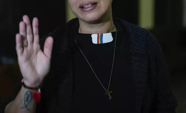 Rev. Elaine Saralegui, wearing a rainbow flag on her clerical collar, talks at the end of a service at the Metropolitan Community Church, an LGBTQ+ inclusive house of worship, in Matanzas, Cuba, Friday, Feb. 2, 2024. “This church is a family,” said Saralegui, who has a tattoo of the Jesus fish on one of her forearms and wears a Buddhist bracelet. (AP Photo/Ramon Espinosa)