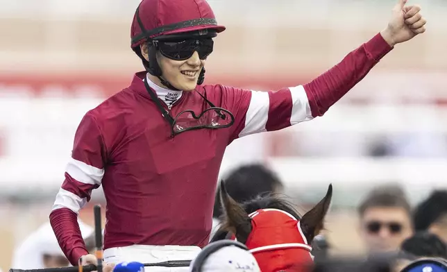 Forever Young's jockey Ryusei Sakai reacts after winning the Group 2 UAE Derby over 1900m (9.5 furlongs) at Meydan Racecourse in Dubai, United Arab Emirates, Saturday, March 30, 2024. (AP Photo/Martin Dokoupil)