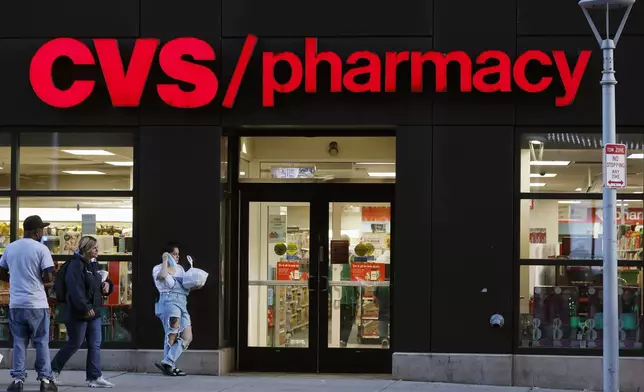 FILE - Customers walk to a CVS Pharmacy, Friday, Nov 4, 2022, in Boston. Don't count on a favorite store being open on Easter Sunday. Several stores will be closed March 31, 2024, in observance of the holiday. (AP Photo/Michael Dwyer, FIle)