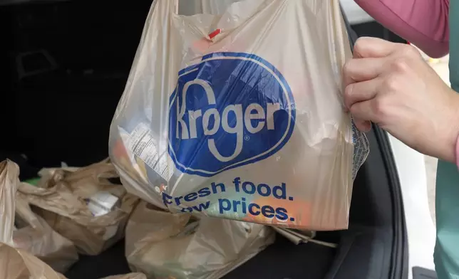 FILE - A customer removes her purchases at a Kroger grocery store in Flowood, Miss., Wednesday, June 26, 2019. Don't count on a favorite store being open on Easter Sunday. Several stores will be closed March 31, 2024, in observance of the holiday. (AP Photo/Rogelio V. Solis, File)