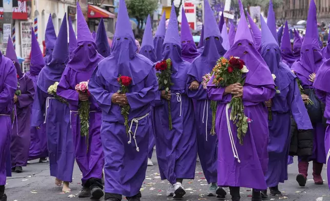 Penitents known as cucuruchos carry flower bouquets during the Jesus the Almighty Good Friday procession, as part of Holy Week celebrations, in Quito, Ecuador, Friday, March 29, 2024. Holy Week commemorates the last week of Jesus Christ’s earthly life which culminates with his crucifixion on Good Friday and his resurrection on Easter Sunday. (AP Photo/Dolores Ochoa)