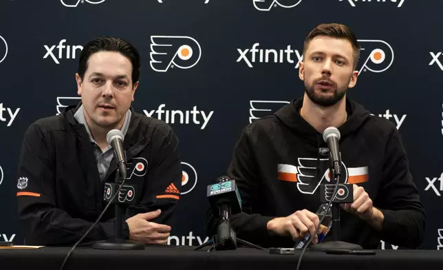 Philadelphia Flyers Ivan Fedotov, right, takes questions from the media as general manager Daniel Briere looks on during an NHL hockey press conference, Friday, March 29, 2024, in Voorhees, N.J. (AP Photo/Chris Szagola)
