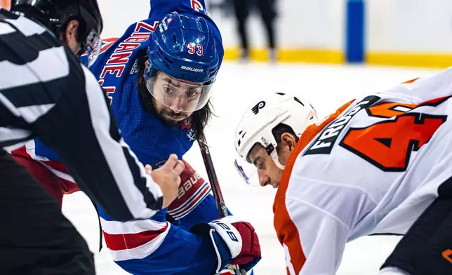 New York Rangers' Mika Zibanejad (93) and Philadelphia Flyers' Morgan Frost, wait for the puck drop on a faceoff during the second period of an NHL hockey game Tuesday, March 26, 2024 in New York. (AP Photo/Peter K. Afriyie)