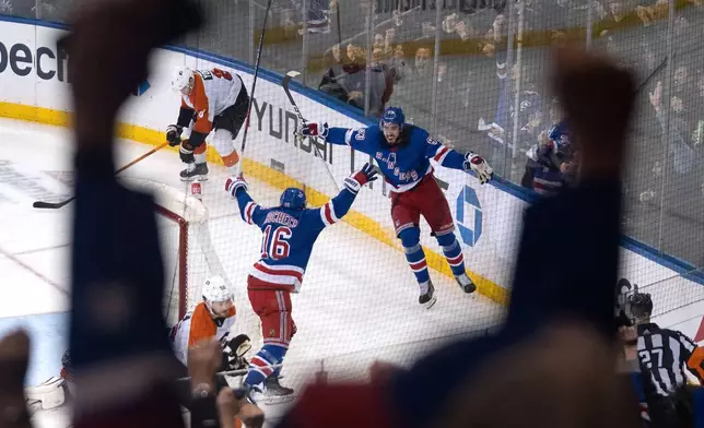 New York Rangers' Vincent Trocheck (16) and Mika Zibanejad celebrate Trocheck's goal against the Philadelphia Flyers during the third period of an NHL hockey game TTuesday, March 26, 2024 in New York. (AP Photo/Peter K. Afriyie)