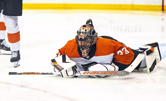 Philadelphia Flyers' Samuel Ersson lies on the ice after making a save against the New York Rangers during the second period of an NHL hockey game Tuesday, March 26, 2024 in New York. (AP Photo/Peter K. Afriyie)