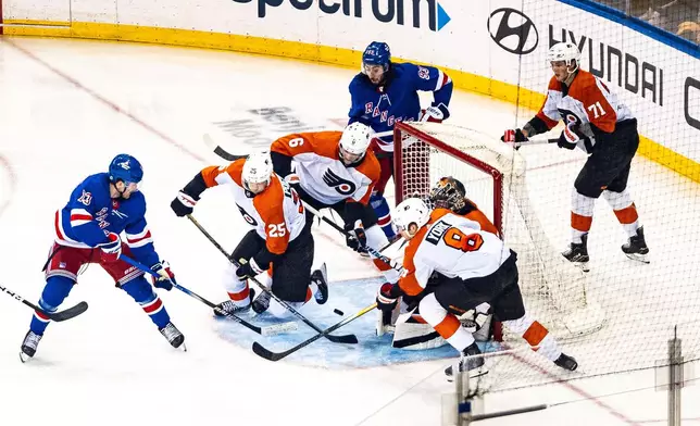 New York Rangers' Alexis Lafreniere (13) scores against the Philadelphia Flyers during the third period of an NHL hockey game Tuesday, March 26, 2024 in New York. (AP Photo/Peter K. Afriyie)