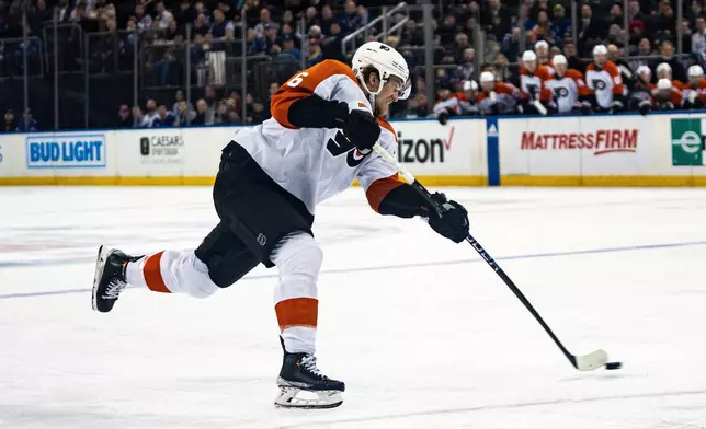 Philadelphia Flyers defenseman Travis Sanheim shoots during the first period of the team's NHL hockey game against the New York Rangers on Tuesday, March 26, 2024, in New York. (AP Photo/Peter K. Afriyie)