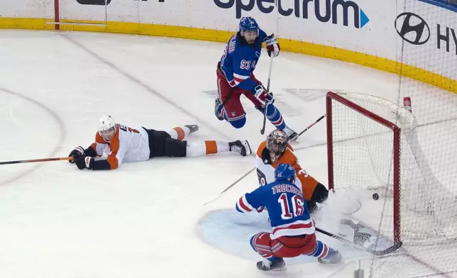 New York Rangers' Vincent Trocheck (16) scores against Philadelphia Flyers goaltender Samuel Ersson (33) during the third period of an NHL hockey game on Tuesday, March 26, 2024 in New York. (AP Photo/Peter K. Afriyie)